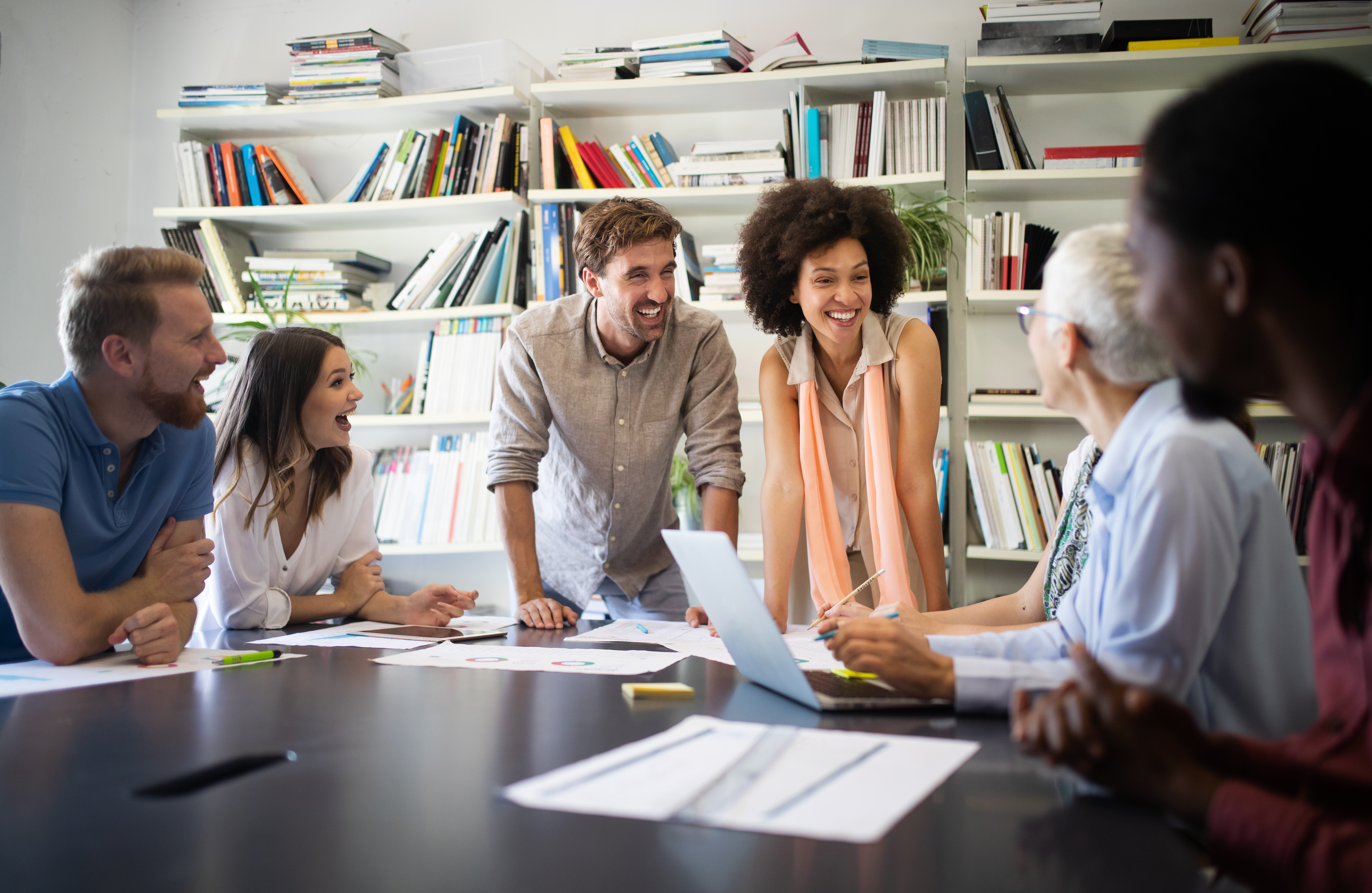 Cheerful coworkers, business people in office during company meeting